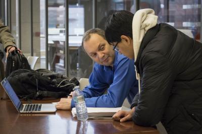 Teaching Professor Lawrence Angrave talks with a student after class.