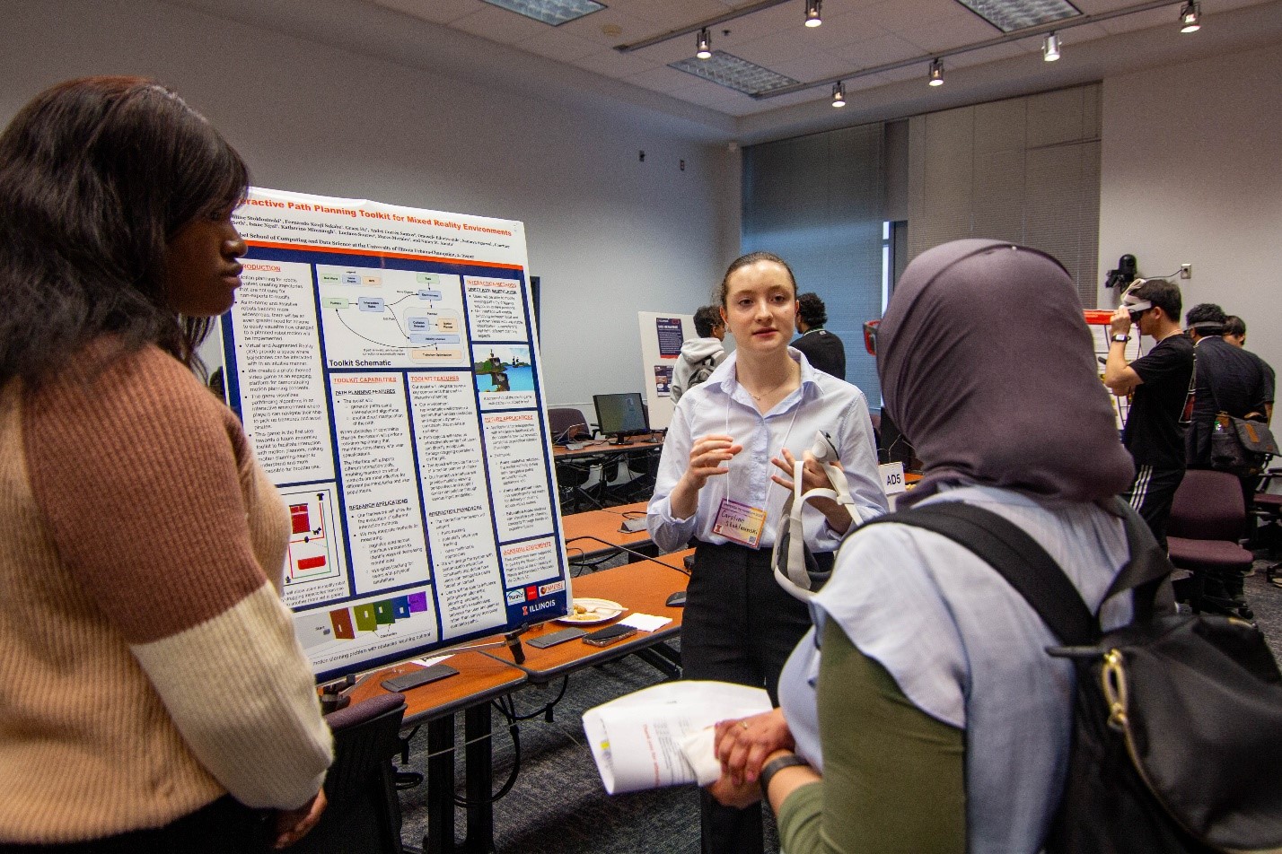 The poster and demo session was packed with immersive projects developed at UIUC, including the Interactive Path Planning Toolkit for Mixed Reality Environments (Caroline Stoklosinski, Fernando Sakabe, Grace He, Andr&amp;eacute; Santos, Omosefe Edomwande, Saumya Agarwal, Courtney McBeth, Isaac Ngui, Katherine Mimnaugh, Luciano Soares, Marco Morales and Nancy Amato -Computer Science-).