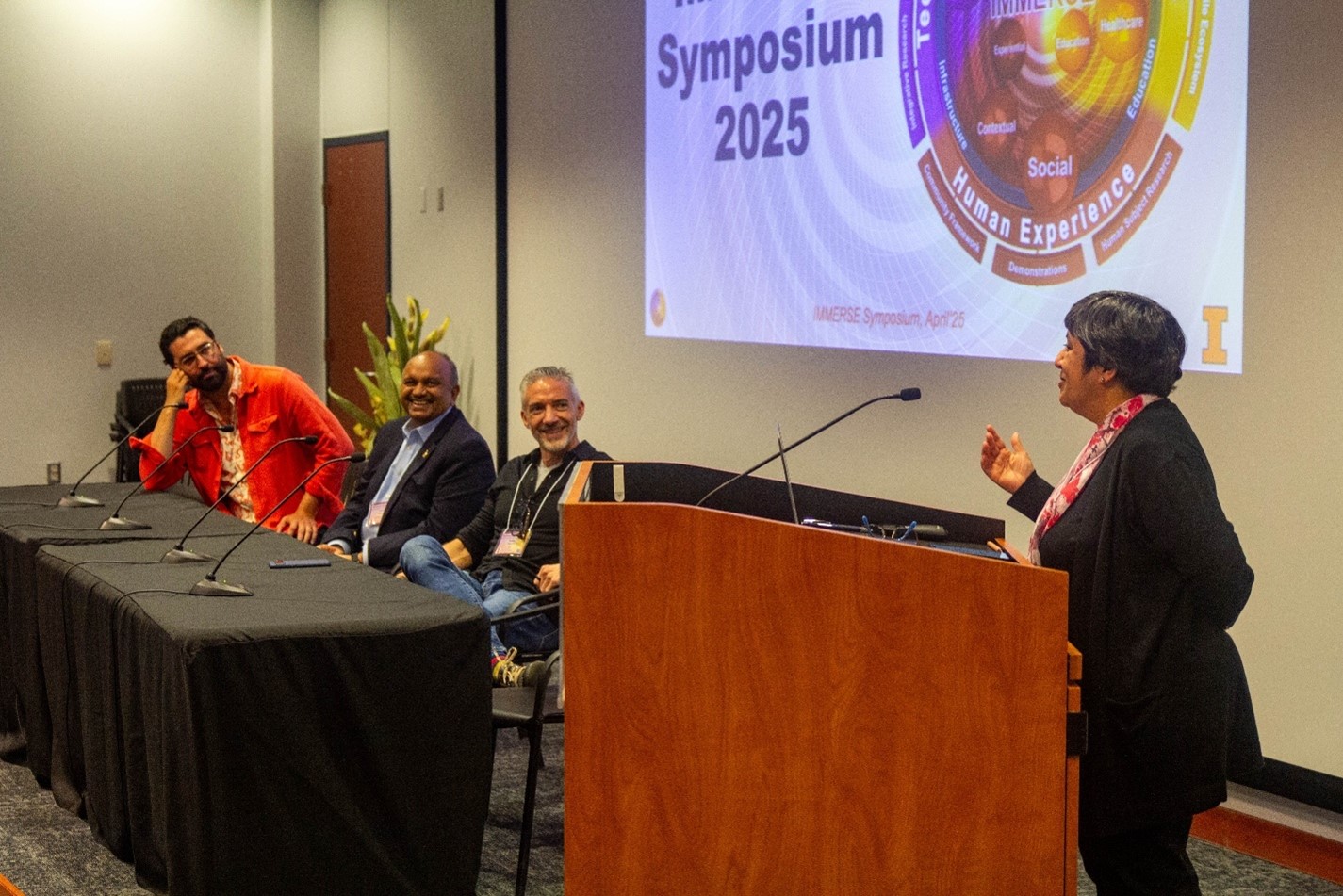 Sarita Adve, IMMERSE Director and Richard T. Cheng Professor of Computer Science, addresses panelists of the &amp;ldquo;What did we get right? What did we miss?&amp;rdquo; concluding panel. L-R: Lars Jan (Early Morning Opera &amp;amp; CalArts), Amitabh Varshney (University of Maryland), Robert Shearer (Meta), Sarita Adve (UIUC).