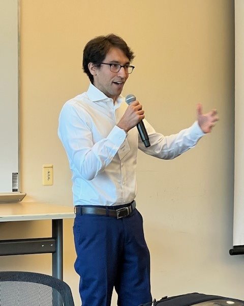 Tal August presents to the AICE 2025 fall symposium audience.