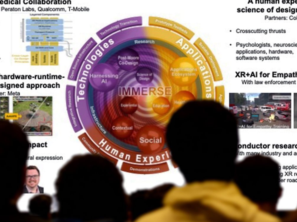 Caption: Attendees looking at slides. The IMMERSE Symposium was held on April 29-30, 2025, with an intentional goal to foster interdisciplinary collaboration.