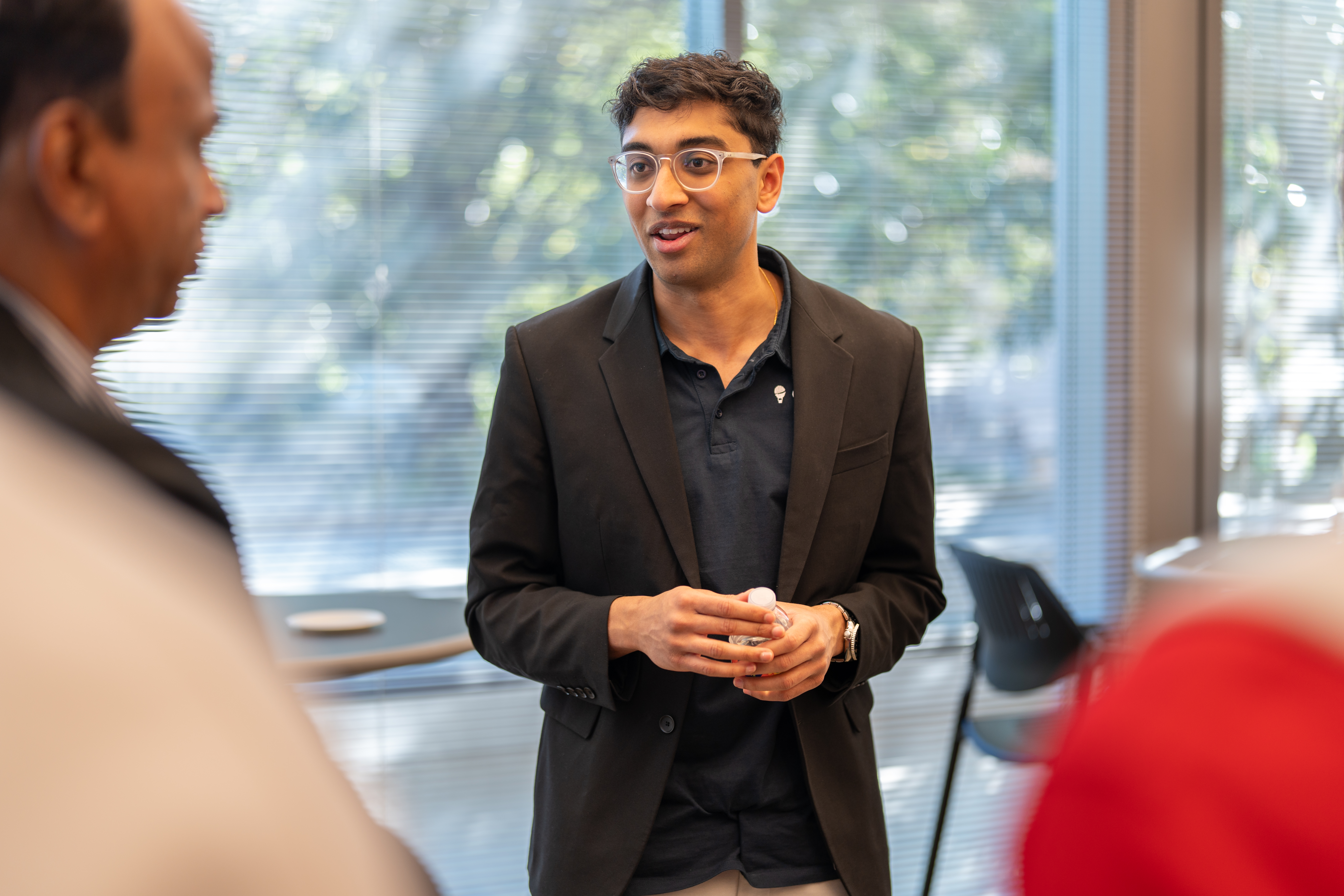 A person stands and talks to another person