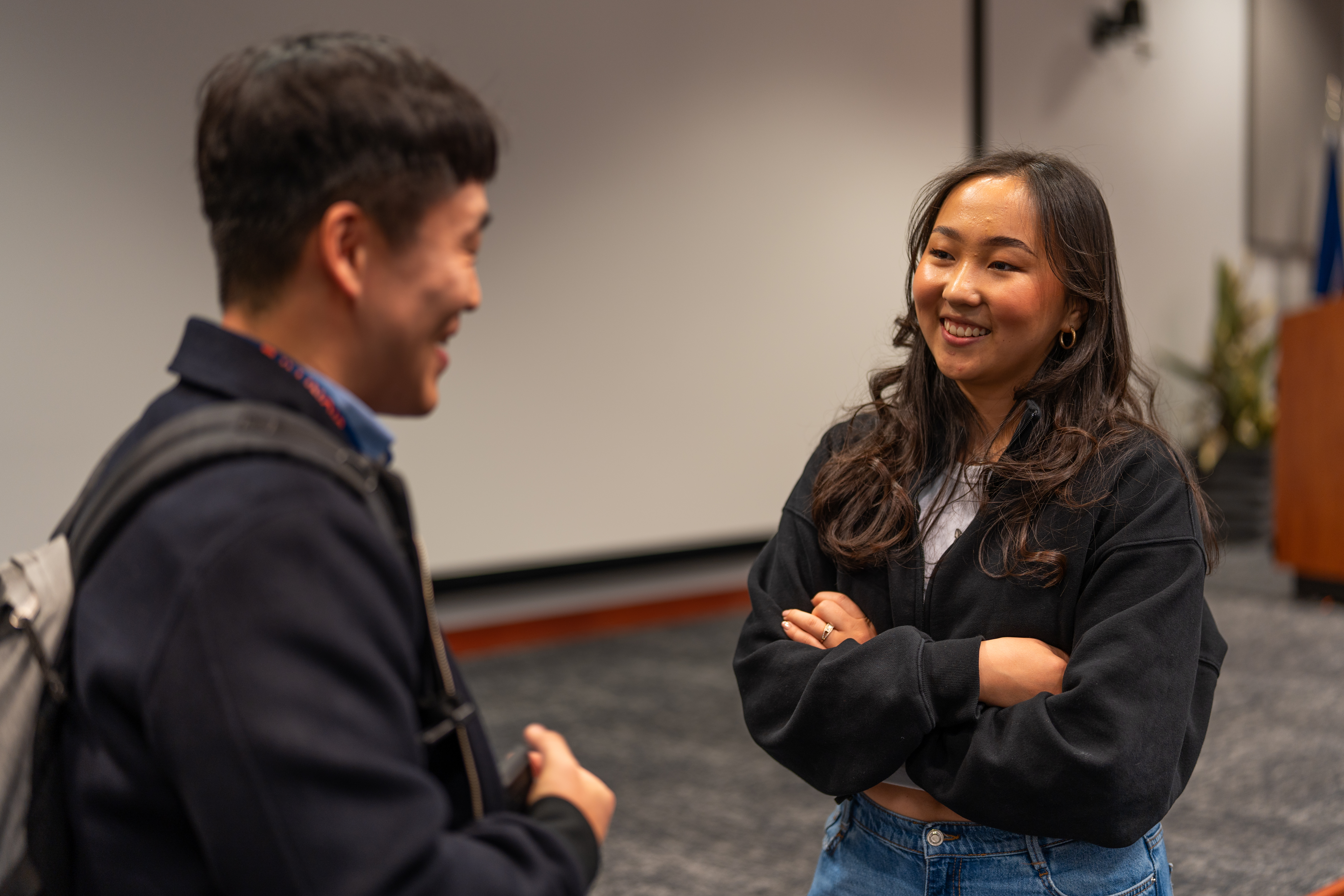 Two people look at each other and talk