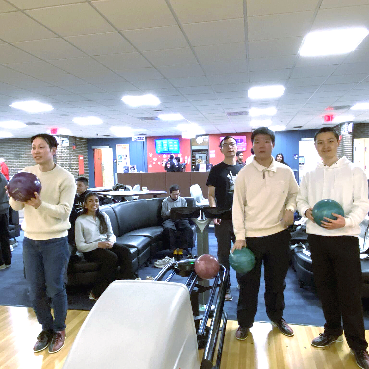 People hold bowling balls.