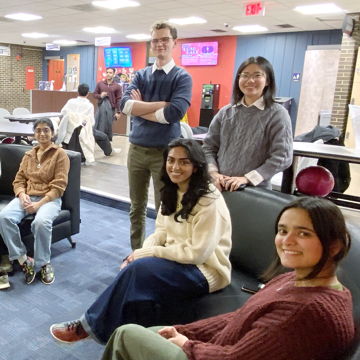 People sitting, standing and smiling. 