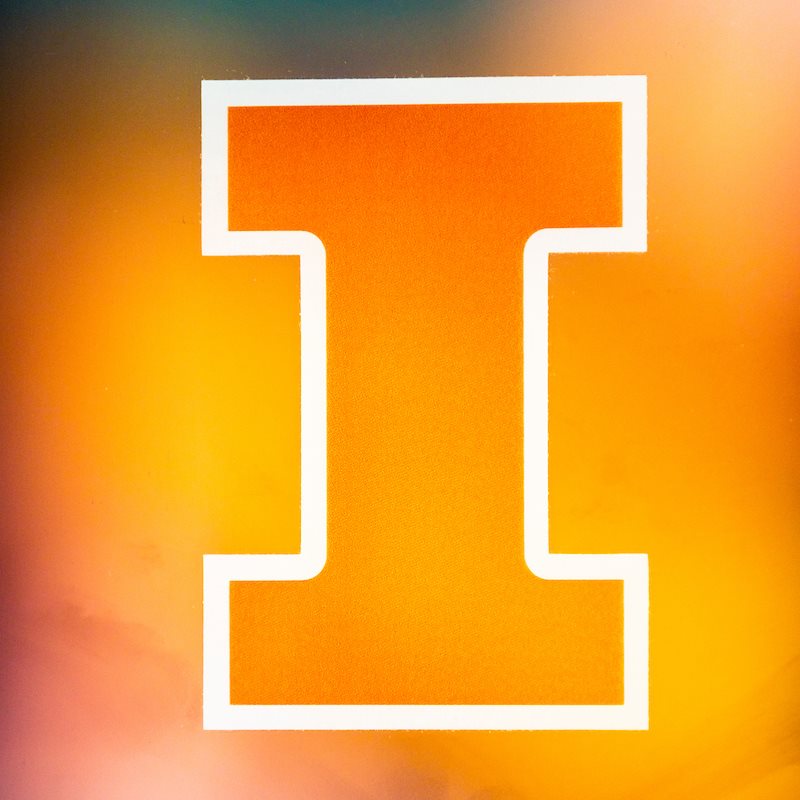 A large orange block I outlined in white with a smokey orange background.