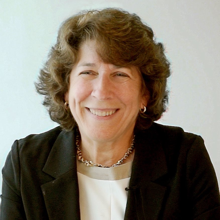 Columbia University professor Kathleen McKeown, sitting at a desk with her hands folded.