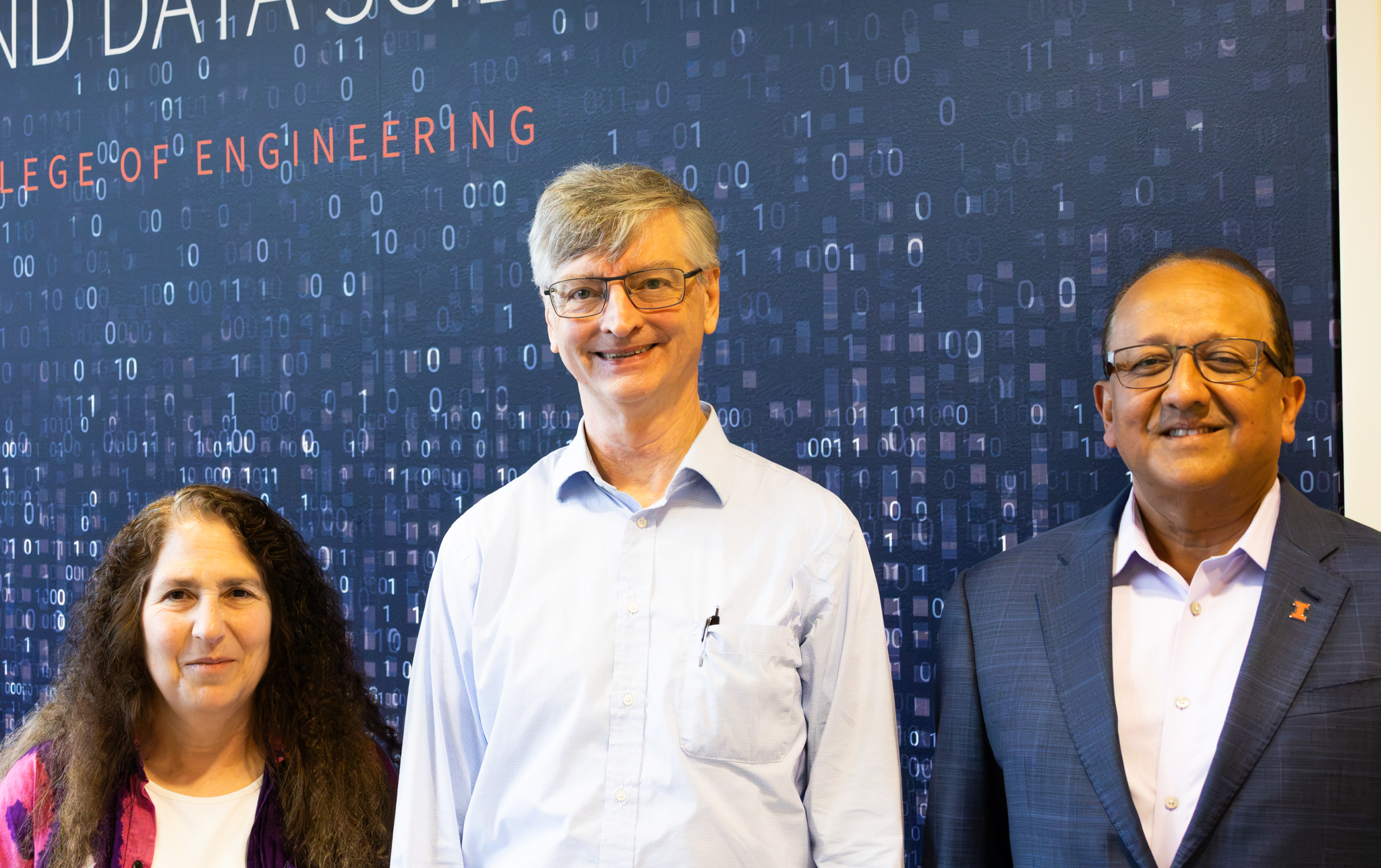 Three people pose for a photo