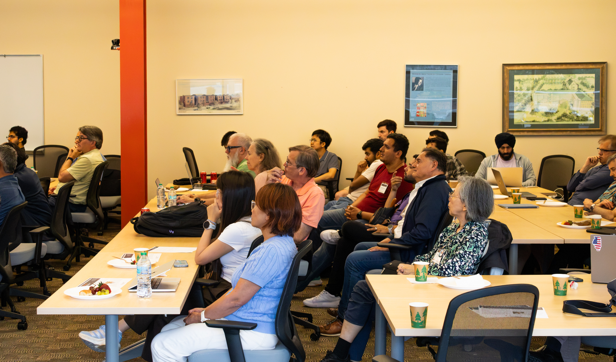 People sit at tables in a conference room