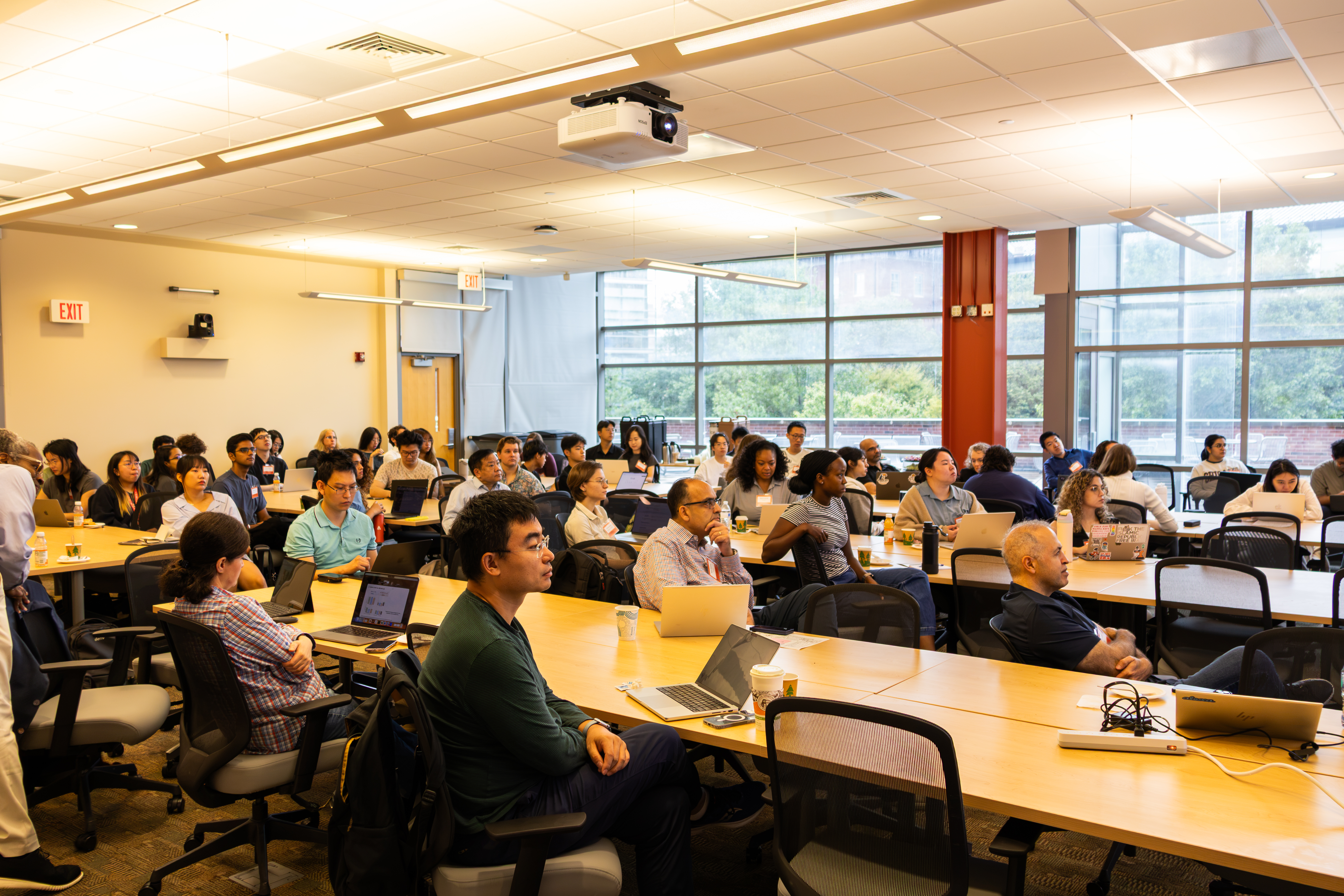 People sitting at tables in a conference room