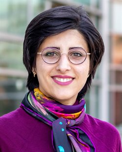 Illinois CS professor Elahe Soltanaghai headshot outside on campus with trees and a building in the background.