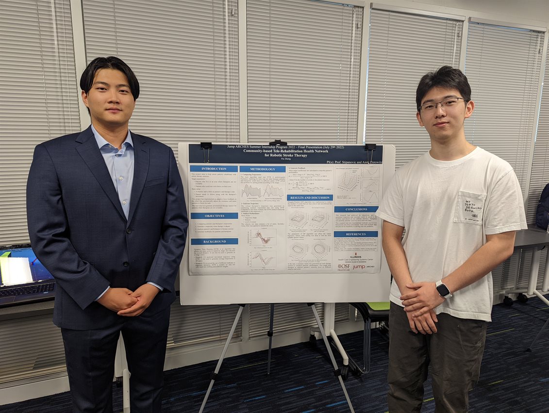 Pai Zheng (left) and Zehao Li stand in front of their research poster.