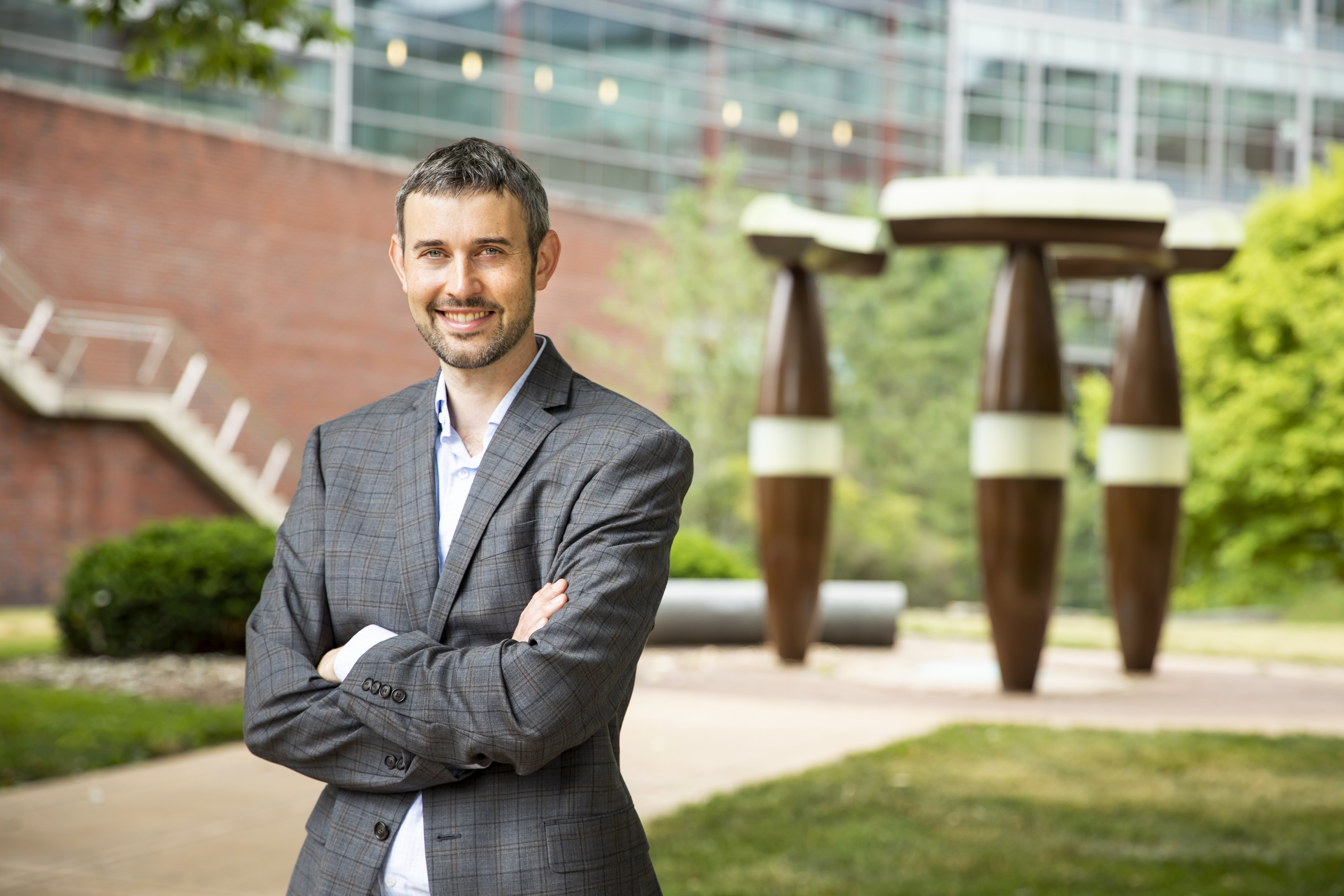 Illinois CS professor Derek Hoiem stands for a portrait picture in front of the Thomas M. Siebel Center for Computer Science.