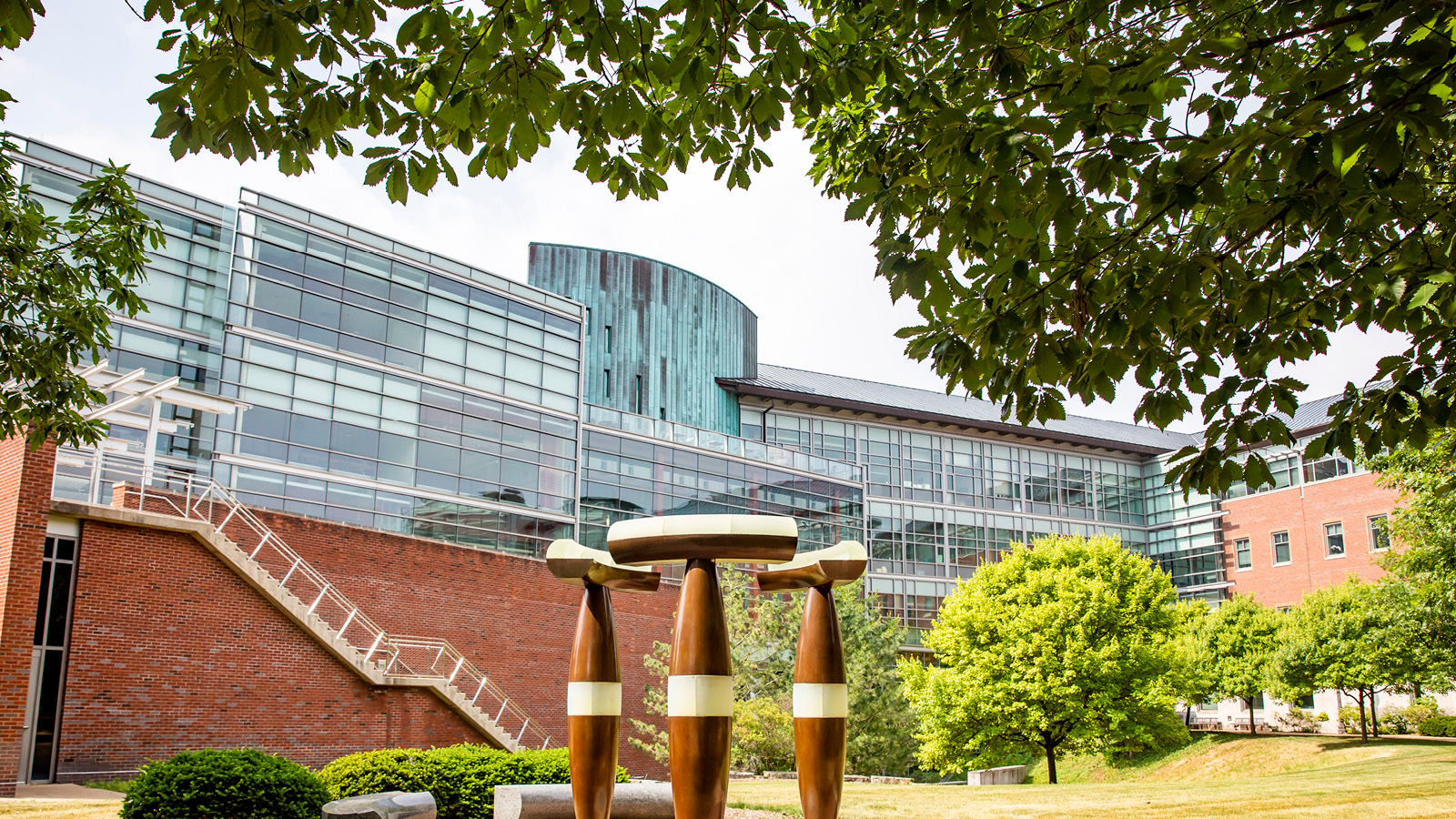 The exterior of the Siebel Center for Computer Science with mushroom-like sculptures in front.