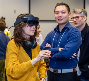 While others watch, a person tries an immersive virtual reality (VR) headset.