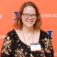 Tiffany Joyner winner of the Staff Award stands in front of an orange banner at the 2024 Computer Science Celebration of Excellence