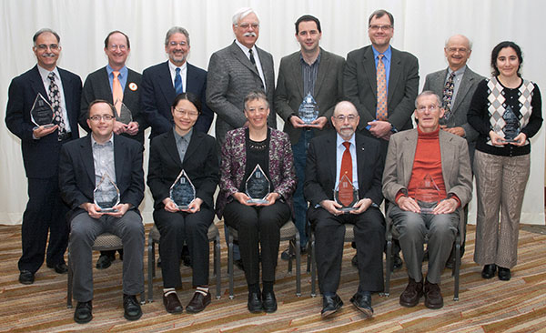 2013 Illinois Computer Science Alumni Awards Winners. Seated, from left: Jed Taylor, Shan Lu, Sandra Rankin, H. George Friedman, and William Kubitz. Standing, from left: Mehdi Harandi, Channing Brown, Sam Kamin, Dennis Mickunas, Steven LaValle, CS Department Head Rob Rutenbar, Milos Ercegovac, and Svetlana Lazebnik.