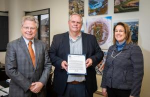 Andreas C. Cangellaris receives a letter from Brad Martin from the NSA Research Directorate that signifies the National Security Agency recognition of the Illinois as one of agencies featured schools, highlighting their relationship over more than 19 years with more than 100 Illinois graduates currently working at the NSA. Joining the group is Provost Susan Martinis,Vice Chancellor for Innovation and Research.